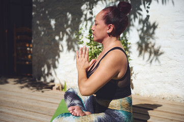 Woman Practicing Yoga in Seated Pose Outdoors in Natural Light