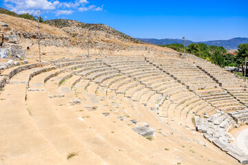 large stone amphitheater with a blue sky in the background, amphitheater. Ruins of the ancient city of Philippi, Greece