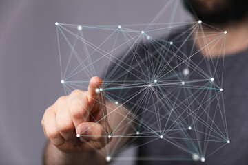Abstract image of a person interacting with a digital network, representing connection and...