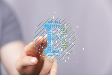 Close-up of a hand interacting with a digital Bitcoin symbol.  Cryptocurrency, finance, technology...