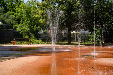 View of splash pad play area in public park.