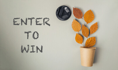 Creative composition featuring autumn leaves in a paper cup with camera lens and text design