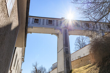 Historic elevated walkway under bright sunlight in winter landscape, Cesky Krumlov in Czech Republic