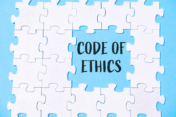 Puzzle pieces forming a message about ethics on a blue background with a focus on integrity