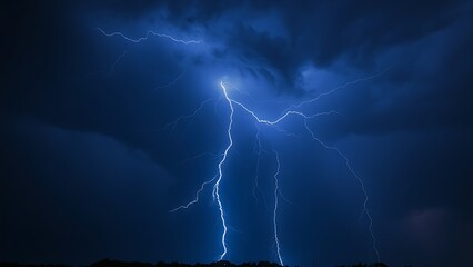 A dramatic lightning strike illuminates the dark stormy sky with electric blue brilliance.
