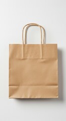 A Simple Brown Paper Shopping Bag with Twisted Paper Handles on a White Background Perfect for Mockups and Branding