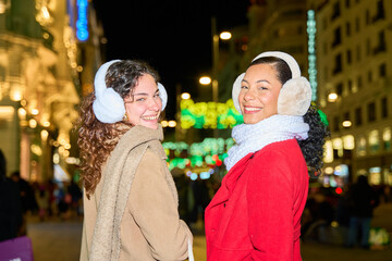 Friends enjoying festive night in city lights