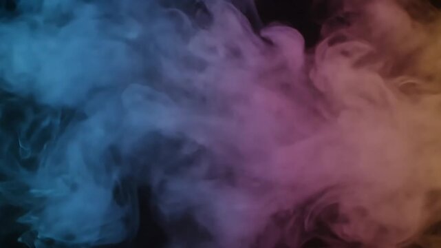 Slow motion abstract colorful smoke on black background.