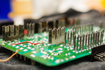 Close-up of a green printed circuit board showcasing intricate electronic components and...