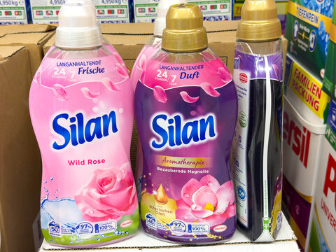 Villach, Austria - July 28, 2025: Silan fabric softener bottles in vibrant colors displayed on a shelf, showcasing floral scents and appealing packaging for laundry care products