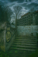 Abandoned urban staircase with sad graffiti face