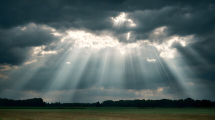 Dramatic Crepuscular Rays Emerging from Dark Clouds over a Flat Field