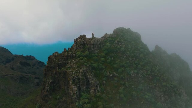 Aerial orbit of misty mountain near Masca revealing ocean through Retamar valley, Tenerife, Canary Islands