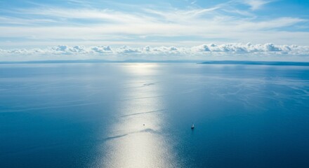 Sunlit expanse of serene ocean, a lone sailboat navigating the tranquil waters under a bright sky