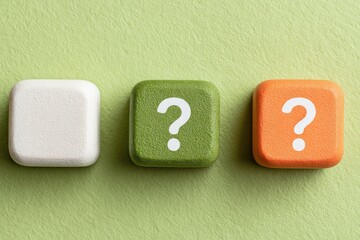 Three small, square, colored buttons, each with a white question mark symbol