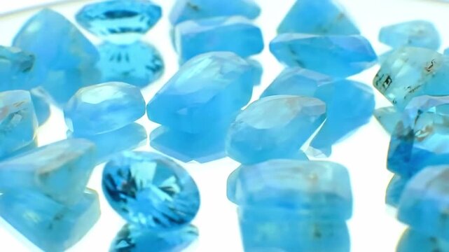 Macro Pan Across Blue Topaz Slices on Mirrored Surface with Crisp Reflection