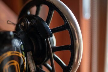 Vintage black sewing machine detail, retro craftsmanship, old technology, mechanical parts,...