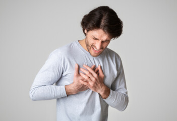 Healthcare concept. Man suffering from chest pain with painful expression