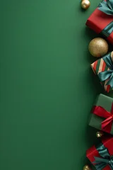 Fotobehang Holiday decorations and wrapped gifts on a green vertical background evoking festive joy and cheer © ActionGP