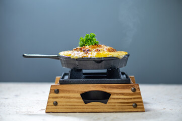 Delicious cheesy baked eggplant with melted cheese and fresh parsley baked cheesy casserole dish in...