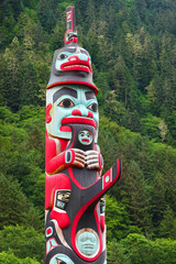 Red Painted Indian Carved Totem Pole in Alaska