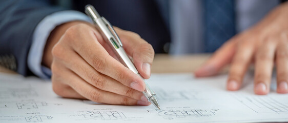 An engineer reviews a blueprint.