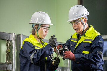Team of Engineers Using Vernier Caliper for Industrial Component Assessment Workers Learning Anchor...