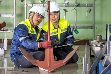 Marine Anchor Inspection: Two Engineers Teamwork Performing Quality Control in Industrial Factory...