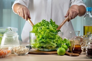 Hand chef mix fresh baby cos salad millet Crab Stick and pour salad dressing in wood blow. Organic Vegetables mix lunch with green salad In bowl. Breakfast fresh salad and clean vegetable