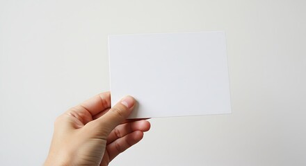 Fototapeta premium Blank Card Held in Hand on White Background