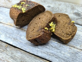 Freshly baked bread with wheat on a rustic wooden table,