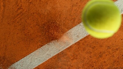 Freeze Motion Detail Shot of Tennis Ball Hitting a Clay Court