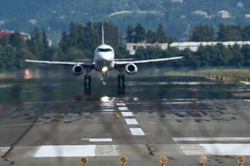 Airplane taking off from airport runway. Blurred background