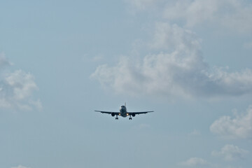 The airplane approaches the airport against a backdrop of clouds. The airplane is ready to land. Airplane in the cloudy sky.