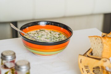 Cold Okroshka Soup With Fresh Herbs and Vegetables Served in a Vibrant Bowl