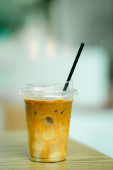 Glass of iced coffee on table in coffee shop.