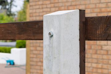 Concrete post supporting wooden garden fence panel