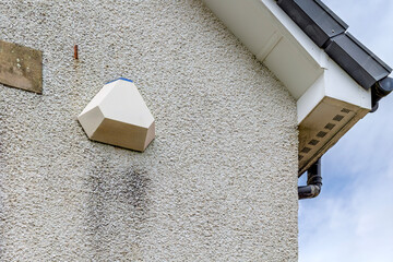 Home security alarm box on exterior wall of residential house