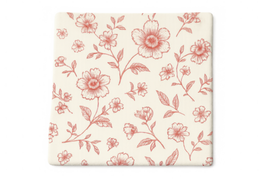 Vibrant red floral print decorating ceramic square coaster, resting against transparent surface with clear visibility