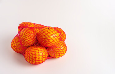 Fresh citrus fruits in net packaging, vibrant and ready to enjoy.
