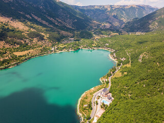 Aerial drone view of the heart-shaped Scanno Lake in the province of L'Aquila, Abruzzo. This place exudes history, peace, and tranquility.