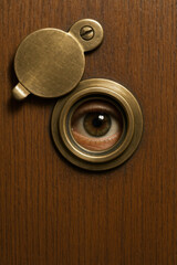 Surveillance through antique brass door viewer

Human eye spying through door spyhole

