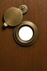 Classic brass peephole with open cover and empty lens

Old-fashioned security peephole open with empty interior