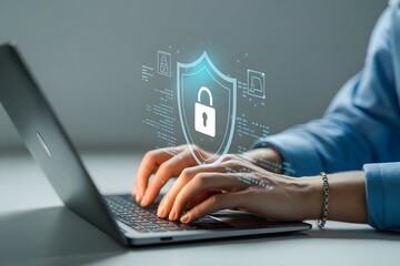 Hands typing on laptop with digital security shield overlay representing cybersecurity data protection online safety and secure internet browsing for personal and business