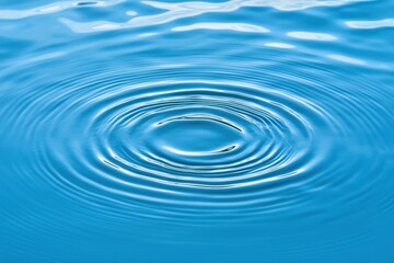 Close-Up View of Water Ripples Creating Circular Patterns on Calm Blue Surface, Capturing Tranquil Nature and Serenity in Every Detail