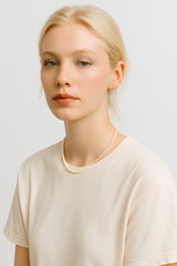 Portrait of a woman wearing a classic pearl necklace with a neutral-tone outfit, showcasing elegance and simplicity, perfect for fashion and jewelry themes in a professional studio environment.