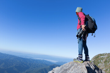 Thai photographer or traveller using a professional DSLR camera in the nature for background