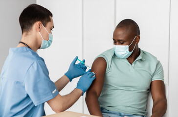 Modern medicine, global patient vaccination program and new normal. Millennial doctor in uniform...