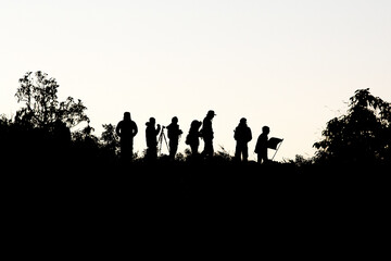 Fototapeta premium Silhouette of travel team on the mountain top.