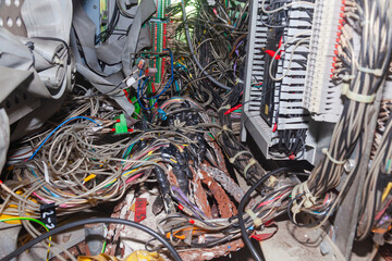 Bunch of connected server electrical cables in a distribution box.